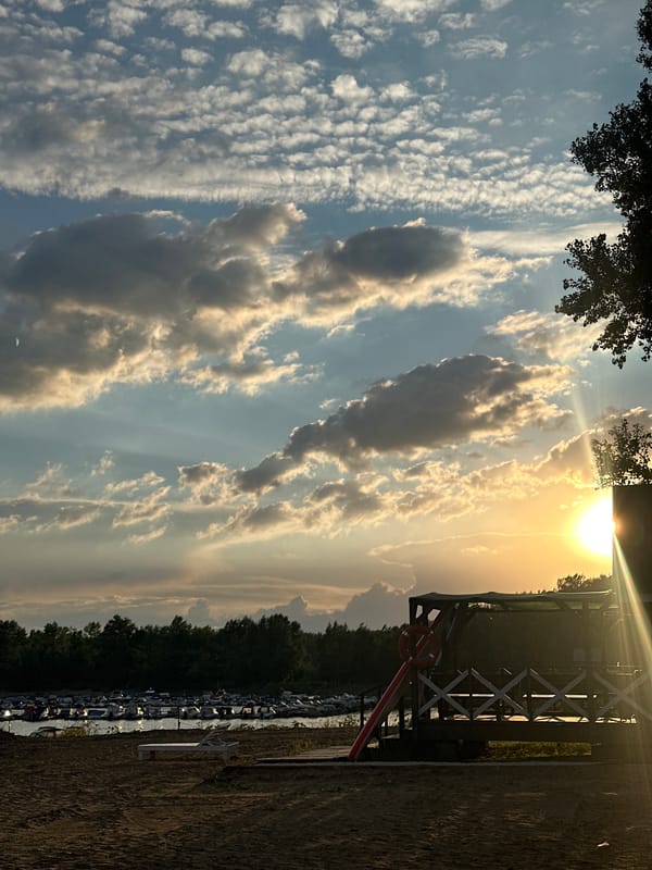 Sunset at the Volga: marina, sandy beach, wooden swings