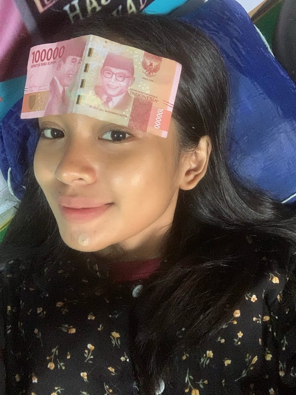 Woman photographs herself with Indonesian banknote across face