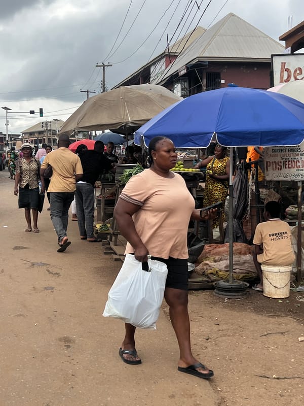 Everyday street life around a busy Nkpor market junction