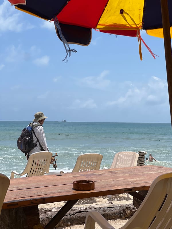 Busy morning on Choeng Thale beach with swimmers, vendors, and cafes