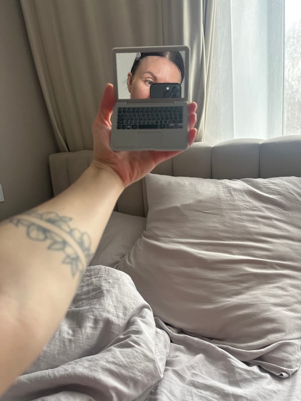 Person examines laptop-shaped compact mirror in Votkinsk bedroom