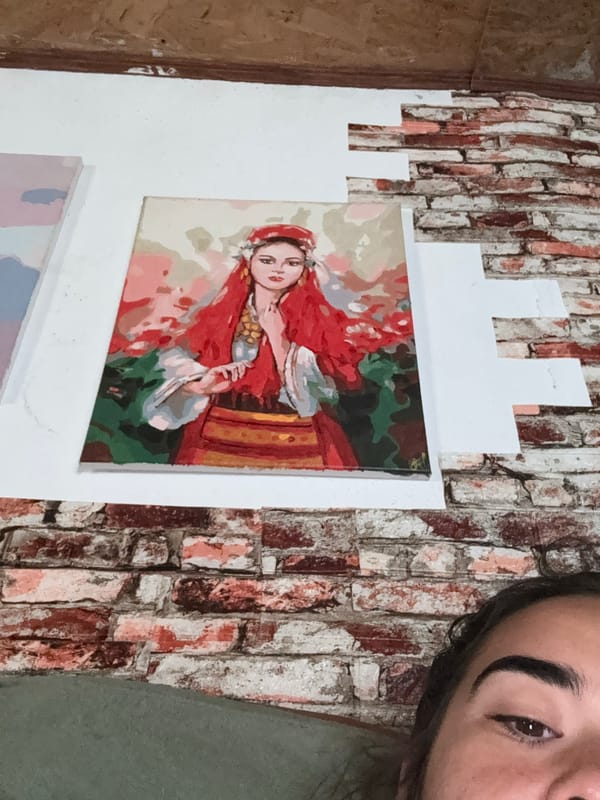 Person photographed in Bulgarian room with woman portrait painting