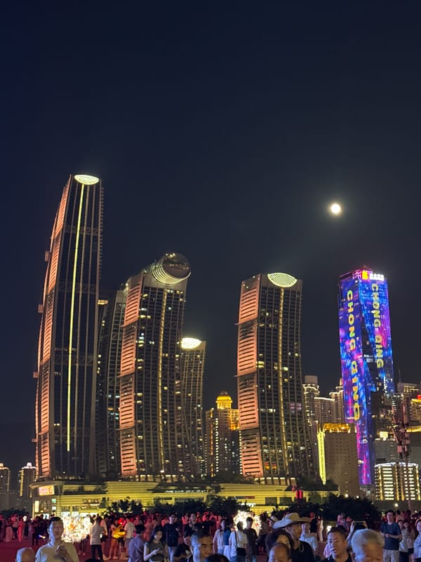 Chongqing's illuminated skyline and evening pedestrian activity captured
