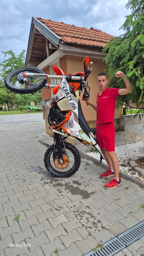 Man rides dirt bike on residential driveway