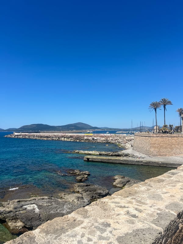 Tourist explores Alghero markets, enjoys gelato on sunny Italian morning