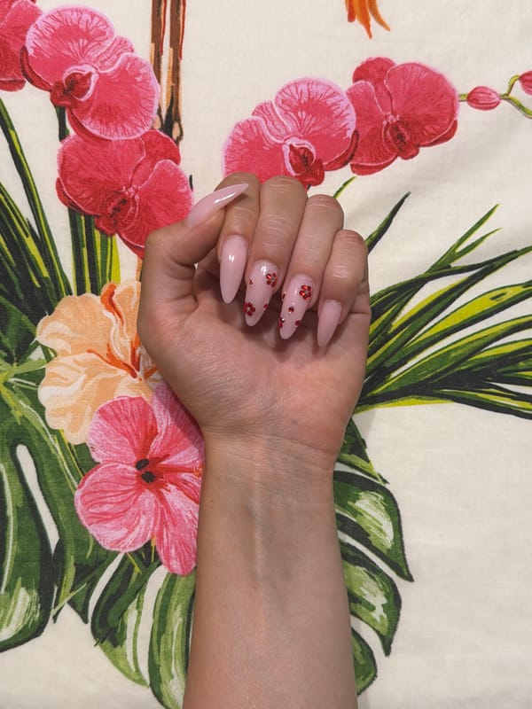 Beauty accessories and manicured nails in a styled flat-lay