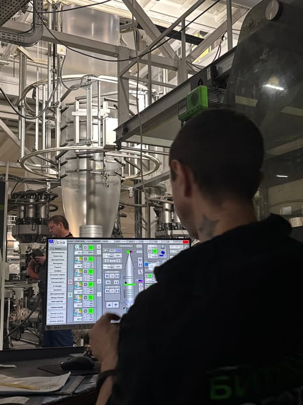 Factory worker operates industrial machinery in Perm manufacturing facility