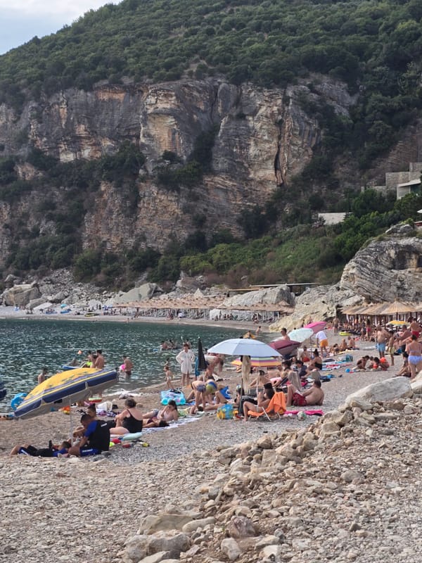 Crowded pebble beach day on Montenegro's Adriatic coast