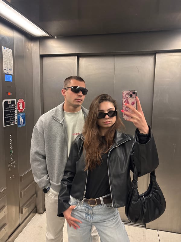 Couple takes sideways selfie in elevator
