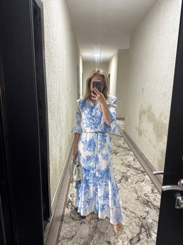 Mirror selfie in a hallway, dressed up in floral