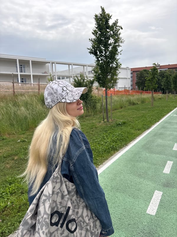 Woman walks cycle track with smartphone in Novate Milanese