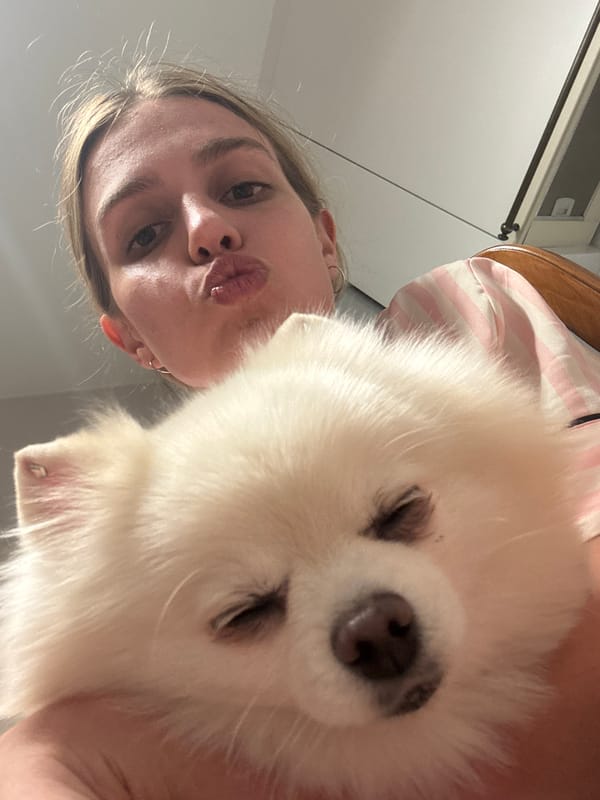 Woman and small dog captured in indoor home setting