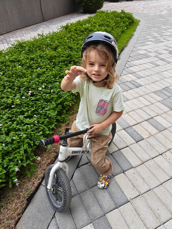 Child rides balance bike in Mumbai morning