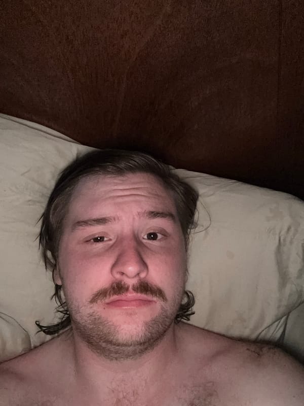Man and Schnauzer dog rest together in Mexican bedroom