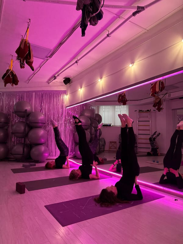 Evening fitness class held in pink-lit studio in Chaikovsky