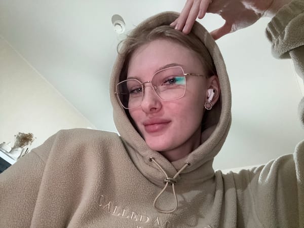Woman takes selfies in beige hoodie in Perm