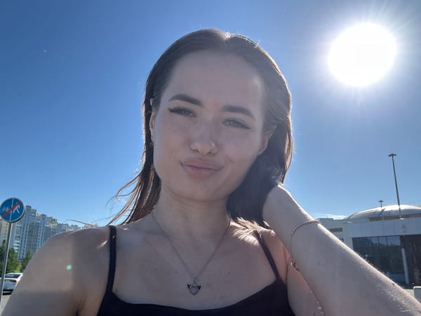 Sunny-day selfies outside a modern building with a red roof