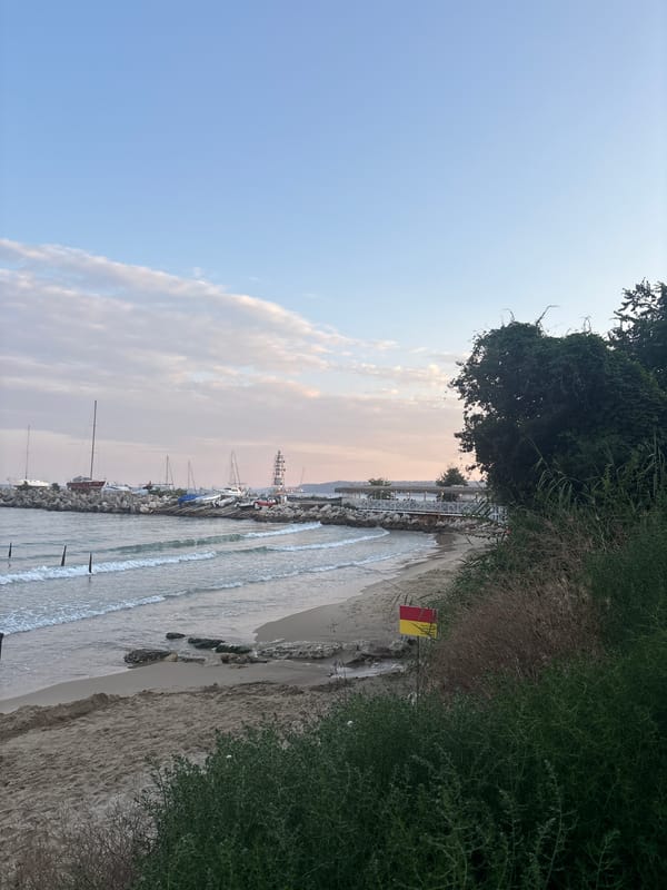 Quiet beach club at day's end, chairs out and sea calm