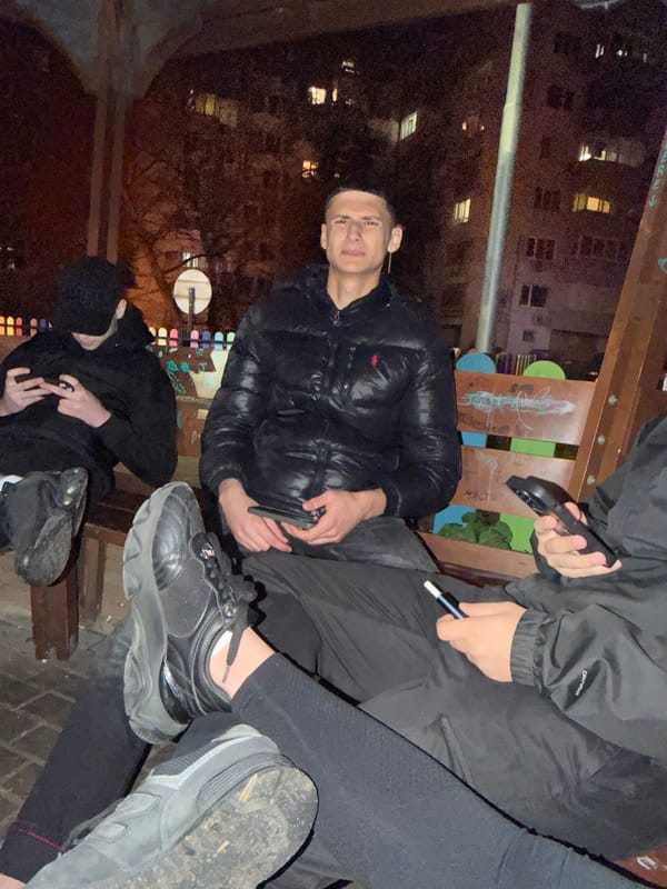 Three people gather outdoors in urban nighttime setting