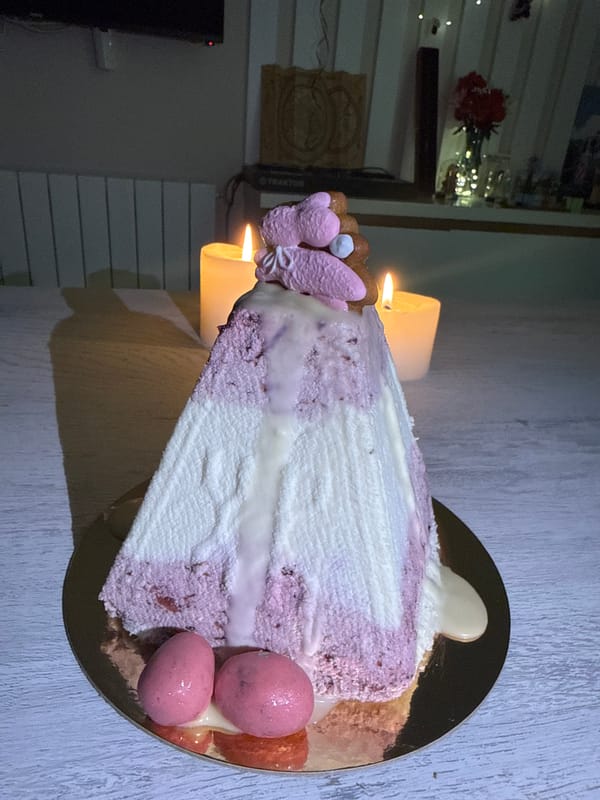 Decorated layered cake photographed on gold plate in Batumi