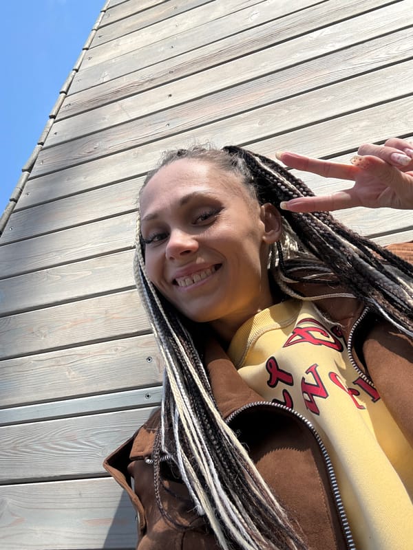Woman poses for photo on sunny day in Rusanovo