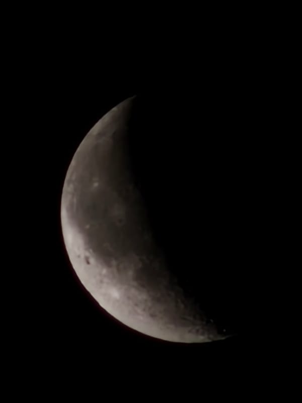 Crescent moon photographed over Esch-sur-Alzette at night
