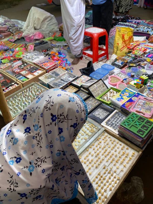 Dhaka street market captured during midday shopping activity