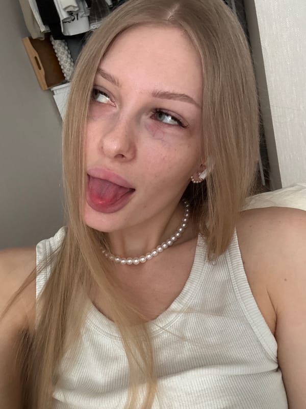 Woman photographed in white top, pearls in Perm apartment