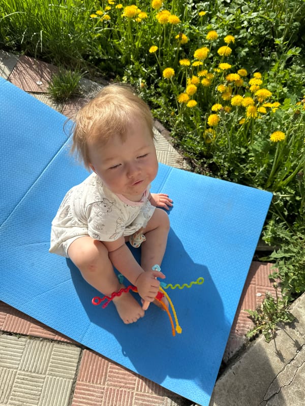 Baby plays outdoors on patio in Nizhny Novgorod, Russia