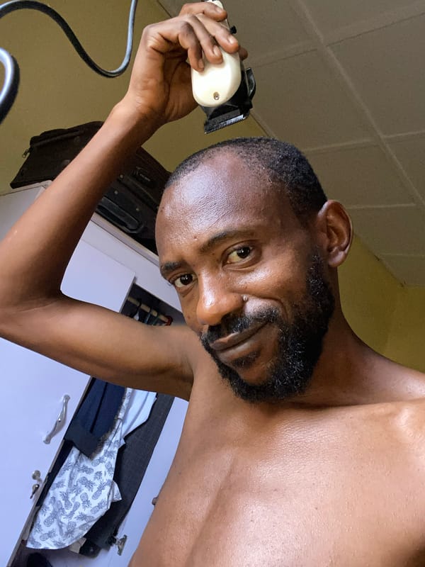 Man gives himself haircut in Sabon Tasha bedroom