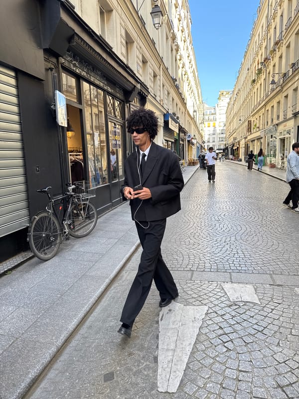 Three young men photographed on Paris cobblestone street
