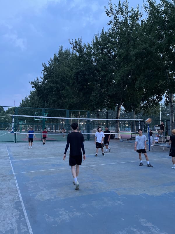 Casual volleyball game on outdoor court in Daxing District