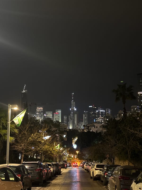 Night street scene captured in Ramat Gan with illuminated skyline