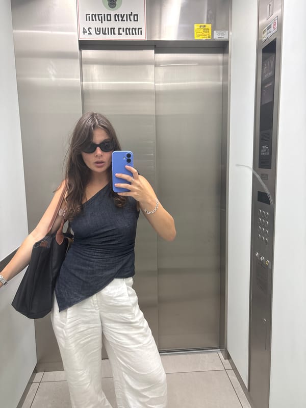 Woman takes selfie in elevator lobby