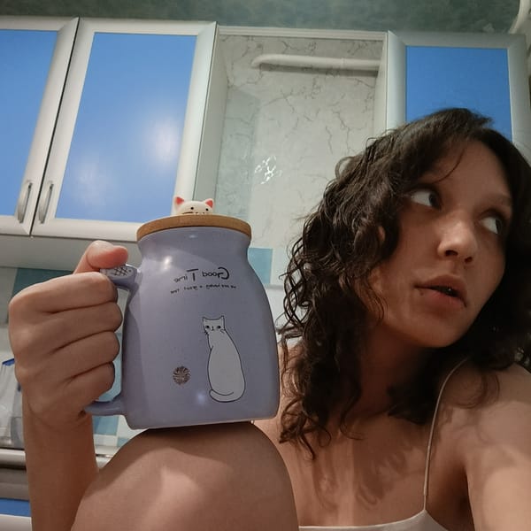 Quiet domestic moments: woman with mug, resting cat captured