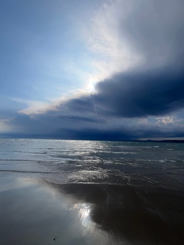 Kitesurfers rig up on Mũi Né beach under stormy skies