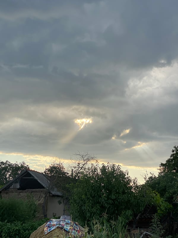 Storm clouds give way to a fiery sunset over rural Moldova