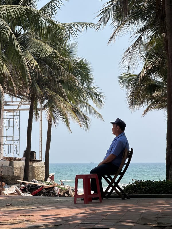 Man contemplates ocean view from chair in Đà Nẵng