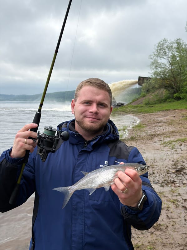 Man catches fish while early morning fishing in Ольховка