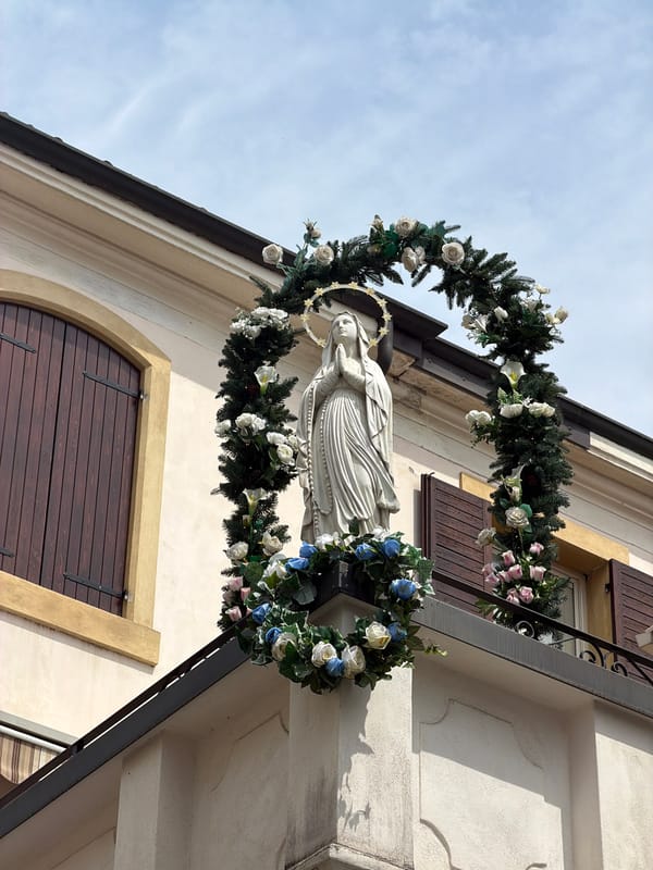 Virgin Mary statue with heart garland observed in Verona