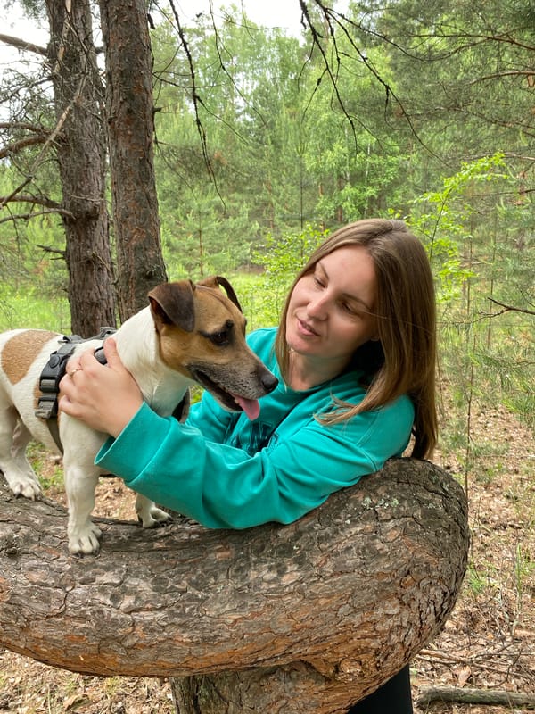 Woman and dog enjoy forest outing in Noviy, Russia