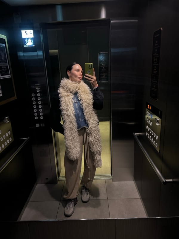 Woman takes elevator selfie with green phone in Osaka