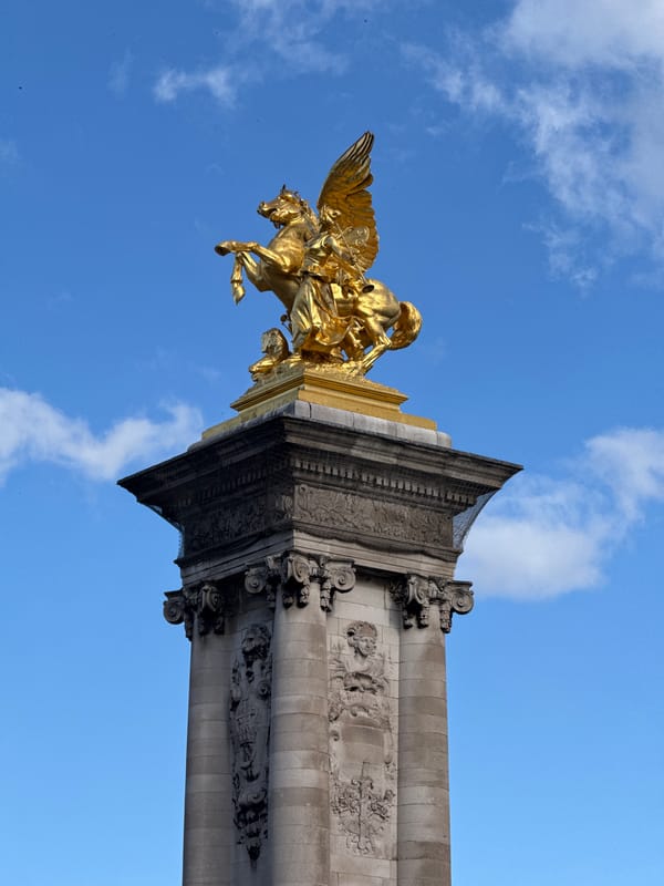 Golden Fame sculpture spotted on ornate column in Paris