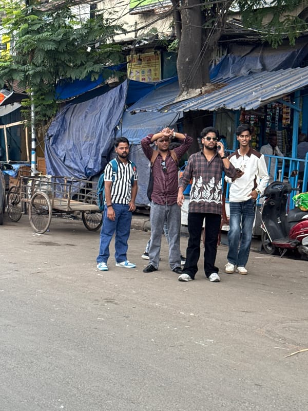 Four men gather on Kolkata street