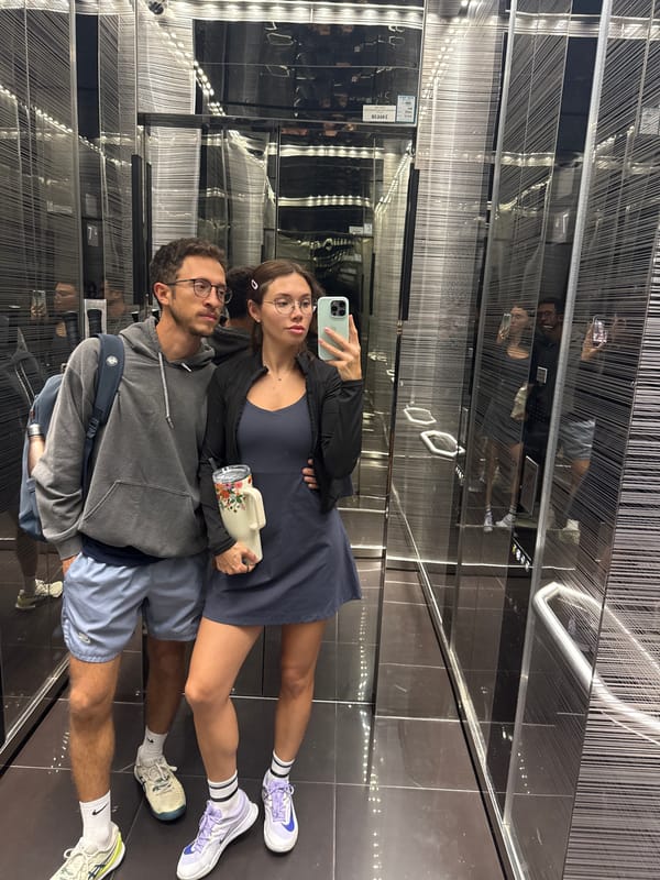 Two young adults take elevator mirror selfie in Tel Aviv