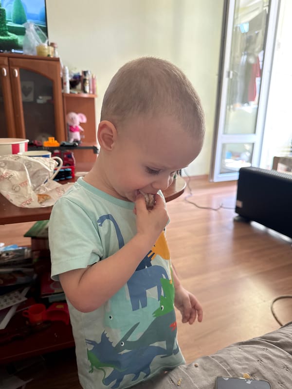 Toddler enjoys snack time at home in Sofia