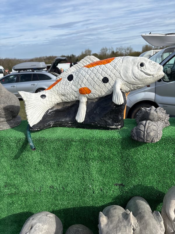 Garden statues displayed at outdoor market in UK