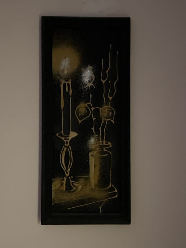 Framed gold abstract artwork displayed on wall
