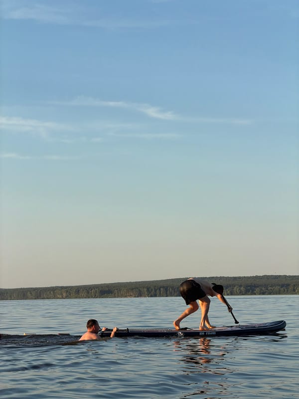 Paddleboarding and swimming on the Kama River at sunset