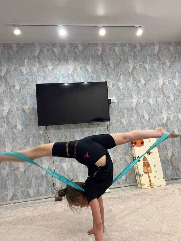 Gymnast trains indoors while spring scenes unfold in Chaikovsky